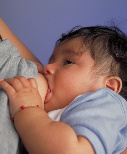 Photo: Breastfeeding infant, by Ken Hammond (Public Domain)