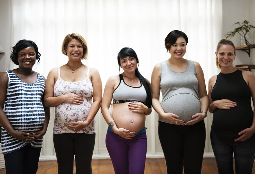 Pregnant women posing in a Childbirth education class.