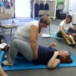 A woman doing a pelvic lift Madriella Doula Workshop hosted by Corey Strouse