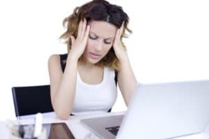 Frustrated woman looking at computer