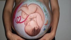 beautiful painting of a baby in the womb painted on a pregnant womans belly