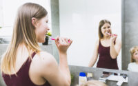 woman brushing her teeth